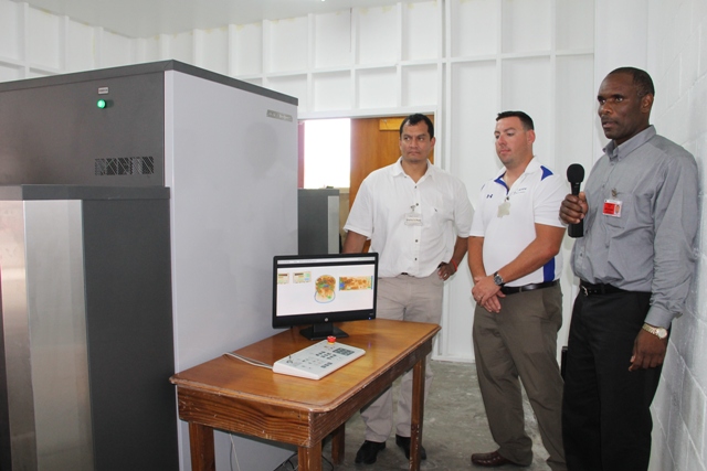 Permanent Secretary in the Ministry of Finance Colin Dore (extreme right) with ADANI officials - Vice President, Operations Scott Ortilani (center) and Sales and Service Manager Salvador Leanos